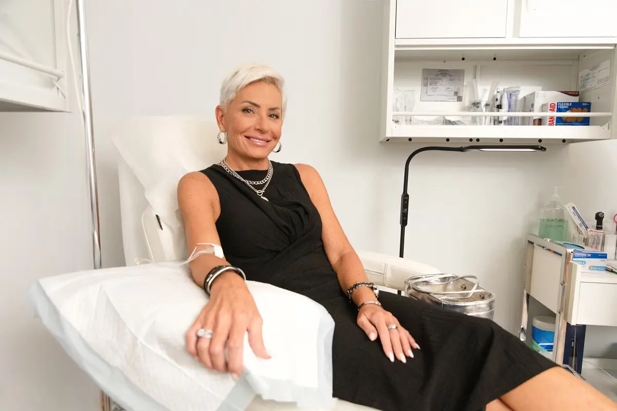 A patient relaxes in the IV chair while Catherine Seidle, APRN sits with her during the drip at Healing Advanced Solutions
