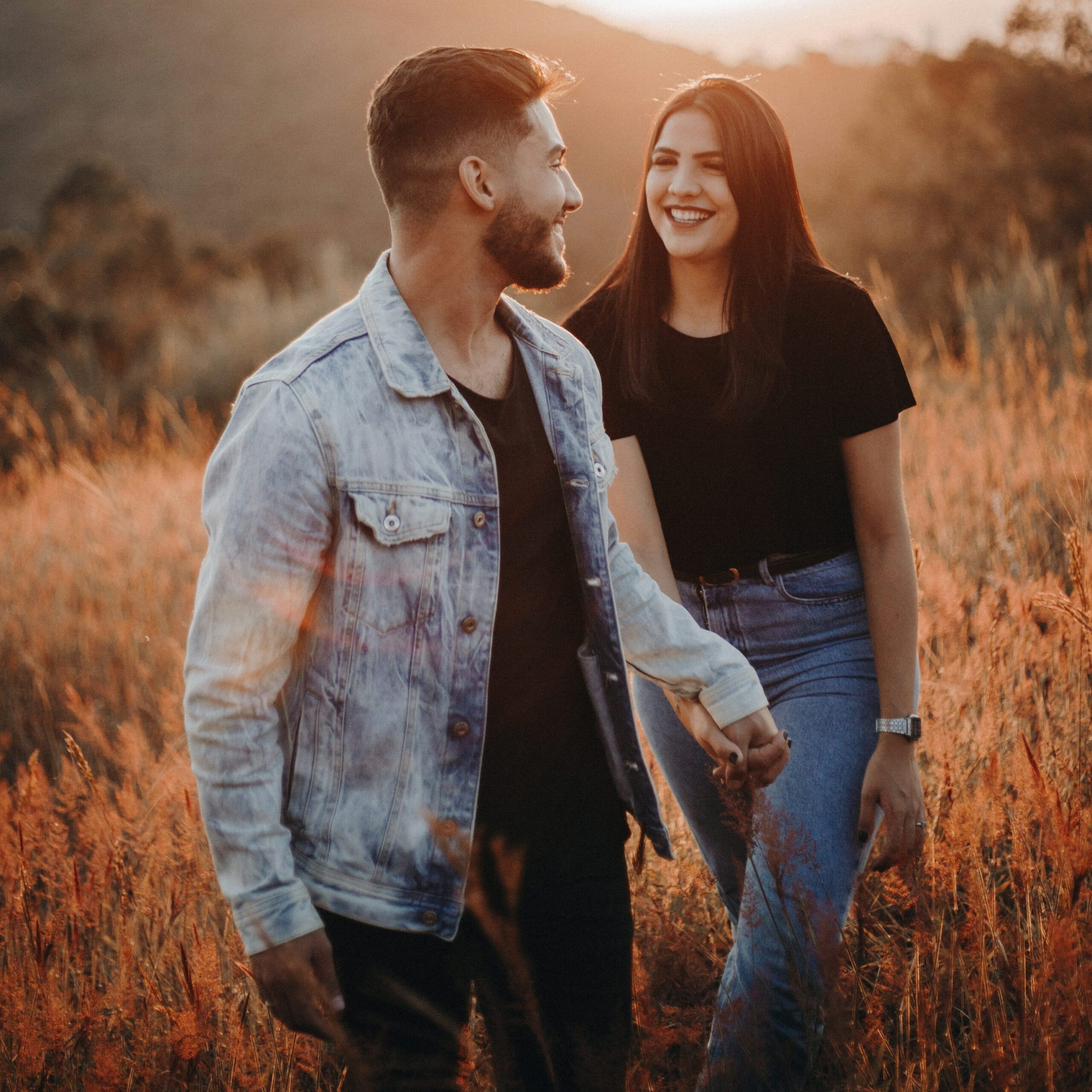 man in blue denim button up shirt standing beside woman in black shirt